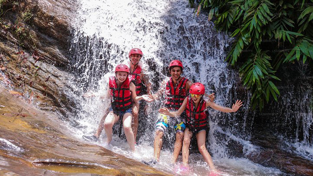 Children in life vests playing at a waterfall